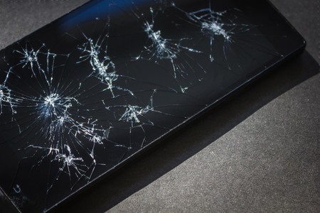 Dark glass in the cracks, the phone after the impact. Breakdown, accident, trouble, bad news. Copy...