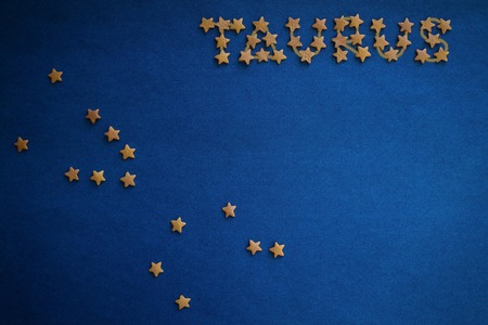 On a blue background, the constellation Taurus is made up of small decorative stars. Horoscope, prediction for those born in May. Top view, drawing made by the author.の写真素材