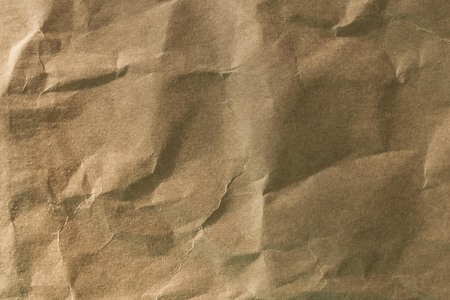 Background brown crumpled paper without pattern. Organic, eco-friendly packaging material. Side...
