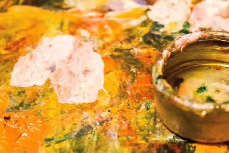 Artist's palette, bright color spots. In the foreground oiler. The edges are blurred.の写真素材