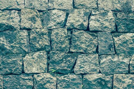 Manually cut stones, antique masonry. Old fortress wall, foundation. Toning.の写真素材