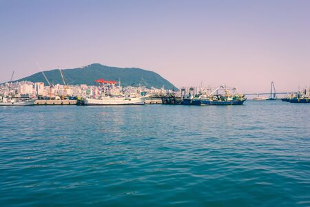 Coastline, ships, bridge. On the shore of the city, modern architecture. View from the water,...