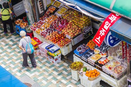 Busan / South Korea - 07/09/2019: Touristic street, market with traditional food, fruits. Traveling in Korea, local culture and traditions.のeditorial素材