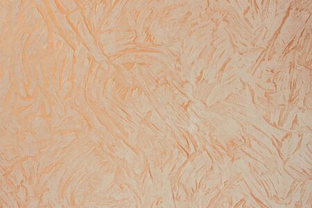Decorative plaster, large strokes, pink, gold and beige shades. Interior decoration, finishing....