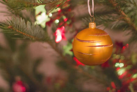 Golden ball on the New Year tree. Holiday, Christmas. The background is blurred.の写真素材