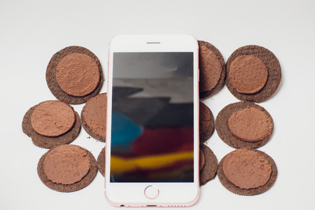 Modern mobile smartphone chocolate cookies stacked served milk the concept of a modern mobile operating systemの写真素材