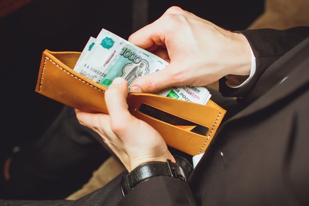 a man holds a clumsy purseの写真素材