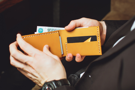 a man holds a clumsy purseの写真素材