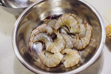 peeling shrimp before cookingの写真素材