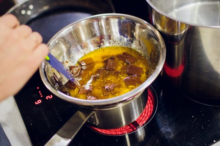 liquid chocolate in a pan, warm brown chocolate foodの写真素材