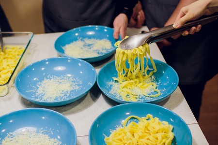 Handmade noodles and ingredients on chopping block. Noodles are an essential ingredient and staple...