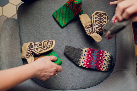 Children's handles in mittens color armchair winterの写真素材