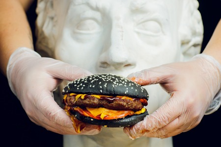 Fresh tasty burger on black background macroの写真素材