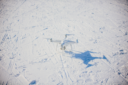 UFA, RUSSIA - February 26,2018: Photo of a flying white professional quadcopter drone camera in the...