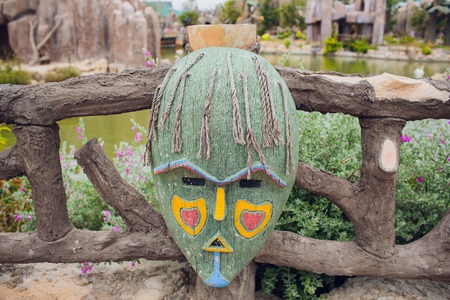 Authentic painted wooden totem Original sculpture Wood tribal sculpture, colored portrait.の写真素材