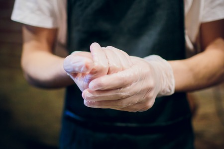 hand in glove board cutting kitchen man maleの写真素材