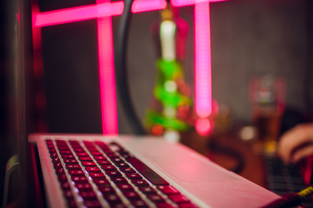 Dj playing the track in the nightclub at a party. In the background color light