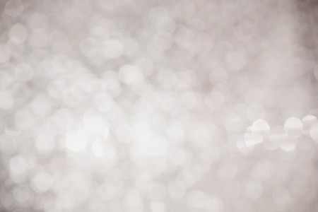 silver Sparkling Lights Festive background with texture. Abstract Christmas twinkled bright bokeh defocused and Falling stars.の写真素材