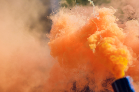 colorful orange smoke bombs in action freedomの写真素材