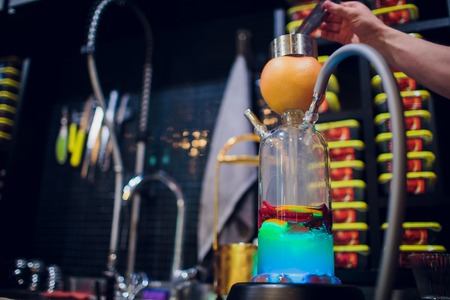 hookah. modern fruit hookah. flask. bowl mouthpiece orange grapefruit hand hooker. cookingの写真素材