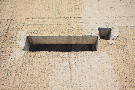 Cement wall with rectangle hole for sewerage and electricity wiringの写真素材