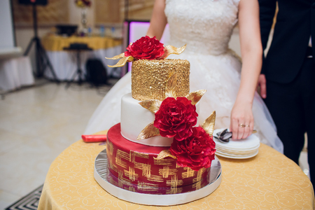 A bride and a groom is cutting their wedding cakeの写真素材