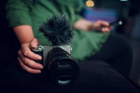 Hipster girl with backpack using vintage photo camera close up, copy space of blank empty mockup, view tourist holding in hands and photograph on device travel on background Barcelona park, sun flareの写真素材