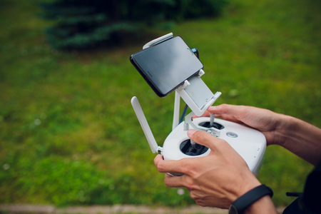 UFA, RUSSIA - 11 JULY 2018: Drone DJI Phantom 4. Quadrocopter against the blue sky with white clouds.のeditorial素材