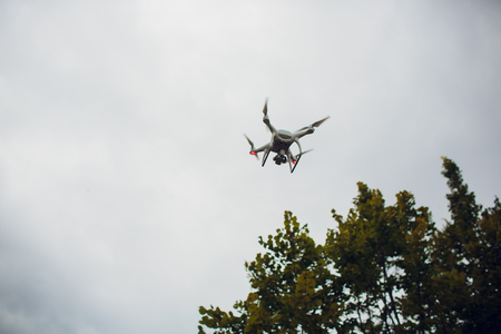 UFA, RUSSIA - 11 JULY 2018: Drone DJI Phantom 4. Quadrocopter against the blue sky with white clouds.のeditorial素材