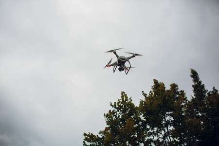 UFA, RUSSIA - 11 JULY 2018: Drone DJI Phantom 4. Quadrocopter against the blue sky with white clouds.のeditorial素材