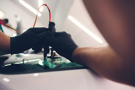 Using tools repairing to fix crack windshield.の写真素材
