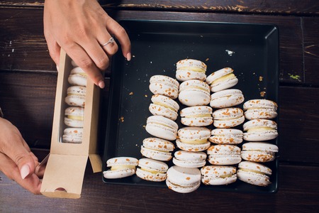 Tasty macaroon box in woman two hand