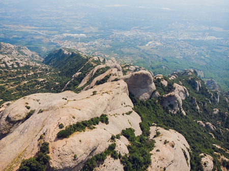 Montserrat, Catalonia, Spain. Top View Of Hillside Cave Santa Cova De Montserrat Or Holy Cave Of Montserrat In Summer Day. Santa Maria De Montserrat Abbey.の写真素材
