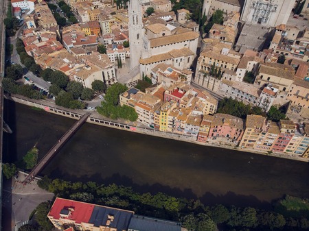 Girona - town in Catalonia, Spain. Onyar River bridge and beautiful, colorful mediterranean architecture. Prominent cathedralの写真素材