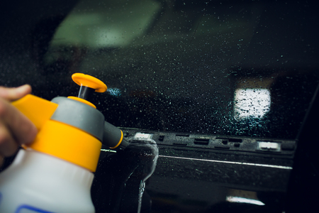 installation of an auto protective film, specialist apply liquid preparations for work preparationの写真素材