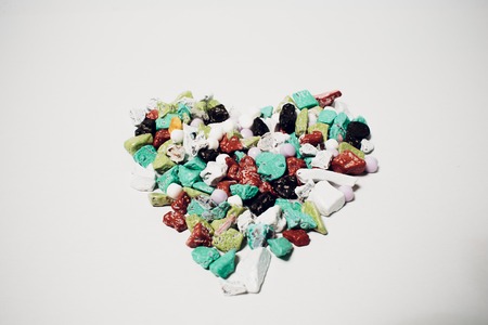 Heart-shaped grains for Valentine's Day background work. Arab sweets. candy by the form of colorful...