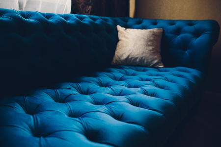 Pretty simple decor of living room with blue sofa and lightの写真素材