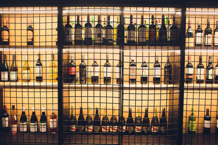 Ufa, Russia, restaurant Syrovar bye Lovkov, 13 October, 2018: wine bottle rack behind black grillのeditorial素材