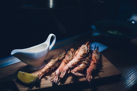 fried until golden brown tiger shrimp are ready in a pan and serving at the tableの写真素材