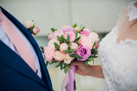 Beautiful wedding bouquet in bride's hands. Hydrangea, eustoma, roses in bride's bouquet