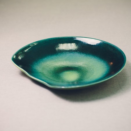 Empty blue plate with wavy edge, Frilled plate in wavy pattern isolated on white background  , Side viewの写真素材