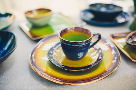 Designer handmade dishes, plates and cups in a stylish boutiqueの写真素材