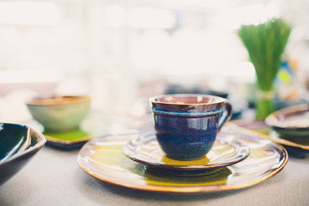 Designer handmade dishes, plates and cups in a stylish boutiqueの写真素材