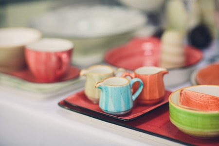Designer handmade dishes, plates and cups in a stylish boutiqueの写真素材