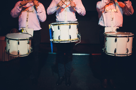 Drummer.The guy holding the drumsticks in his hand.Young man with drumsticks.A bearded man holding a stick in his hands.Marching drumの写真素材