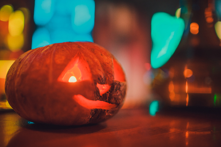 Hookah with smoke on the background of a brick wall with a pumpkin. Abstract Halloween background with pumpkin. Flashes of light, glare of light, an old empty roomの写真素材