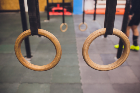 Traditional wooden gymnast rings hanging in the interiorの写真素材