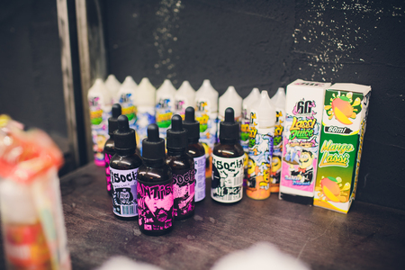 Ufa, Russia, South Vape Shop, 5 November, 2018: E-liquid e-juice High vape for electronic cigarette vaping device , on counter in smoke vapor in vape bar in bottles.のeditorial素材