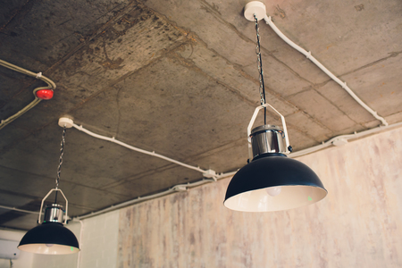 Large lamps with a metal chrome-plated lampshade as part of the interiorの写真素材