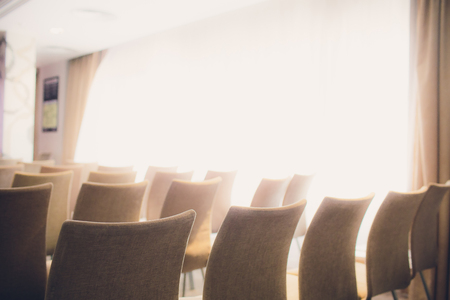 background of row of white seats. Empty hairs in the conference hallの写真素材